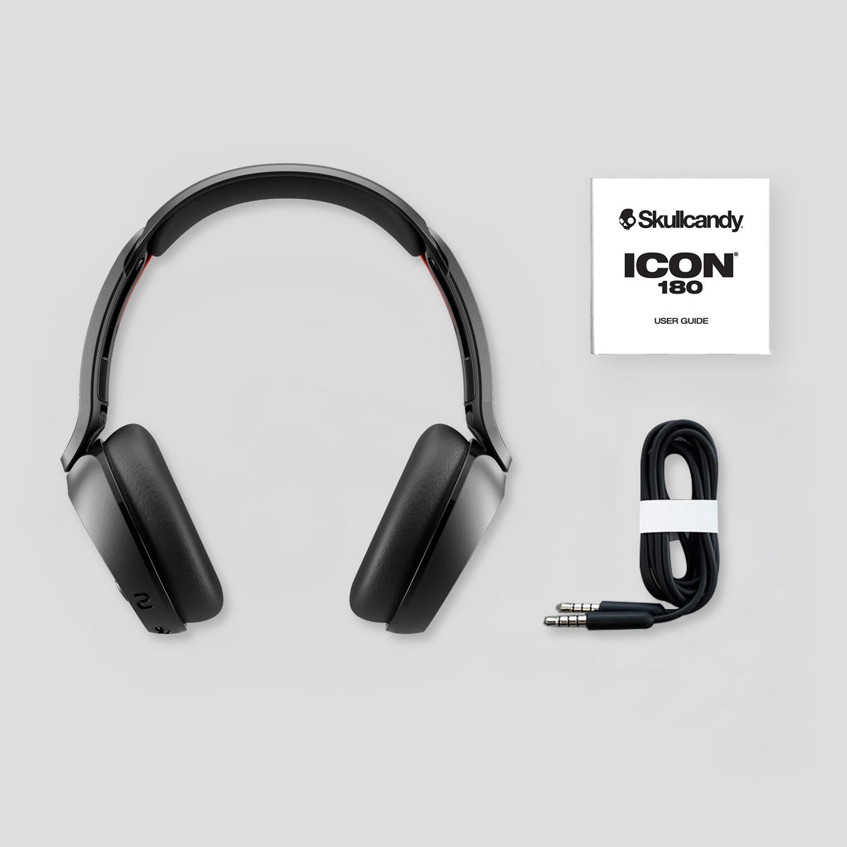 Skullcandy Icon 180 next to 3.5mm AUX cable showing wired fallback option