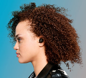 Person wearing Skullcandy Jib True 2 while jogging, showing sweat-resistant performance benefit