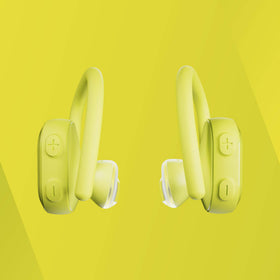 Skullcandy earbuds beside a credit card showing compact scale and portability