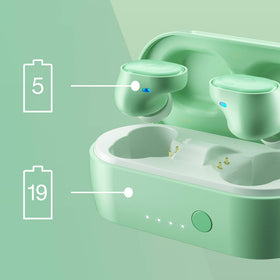 Skullcandy earbuds beside a coin showing compact size
