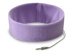 SleepPhones Classic worn on the head for side-sleep comfort near a bed setup.