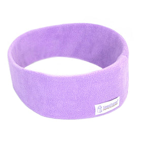 SleepPhones wireless headphones on a bed with cozy lavender fleece for night listening