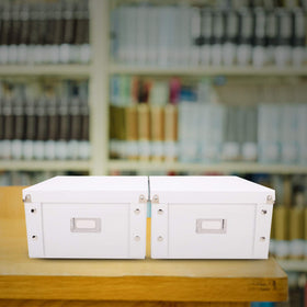 Snap-N-Store on shelf in living room showcasing neat, dust-protected media storage
