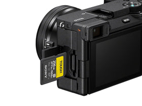 Sony Alpha 6700 beside a compact travel case for easy packing.