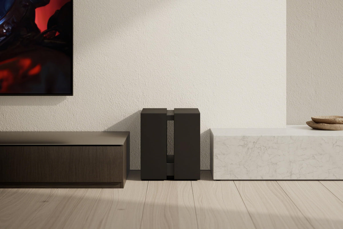 Sony BRAVIA Sub-9 placed in a living room showing room-filling bass with minimal cables.