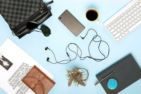 Sony earbuds beside smartphone to show size and phone call compatibility