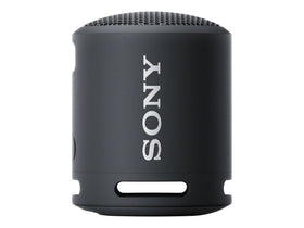 Sony SRS-XB13 next to a hand demonstrating compact size and pocketability