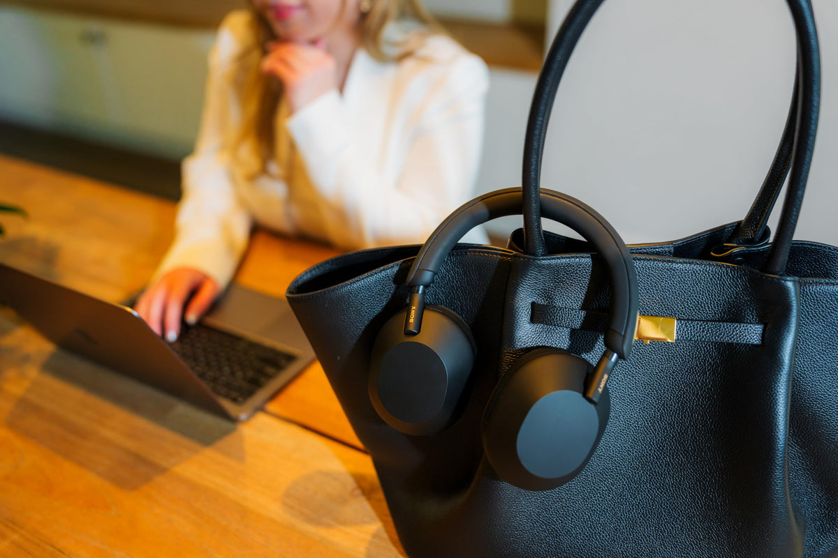 Sony WH-1000XM5 on-ear view emphasizing hands-free calling clarity in busy environments
