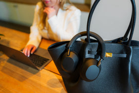 Sony WH-1000XM5 on-ear view emphasizing hands-free calling clarity in busy environments