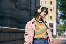 Sony WH-CH520 on commuter in a lifestyle scene showing long battery life for travel benefit
