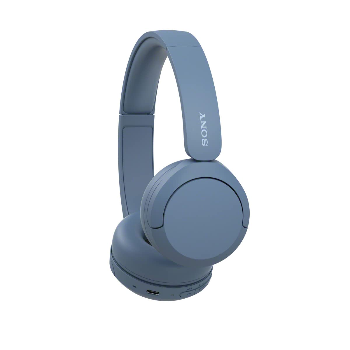 Sony WH-CH520 beside a hand for scale showing compact on-ear size
