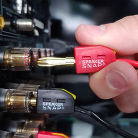 Speaker Snap tool-free banana plug being pressed by hand for quick setup