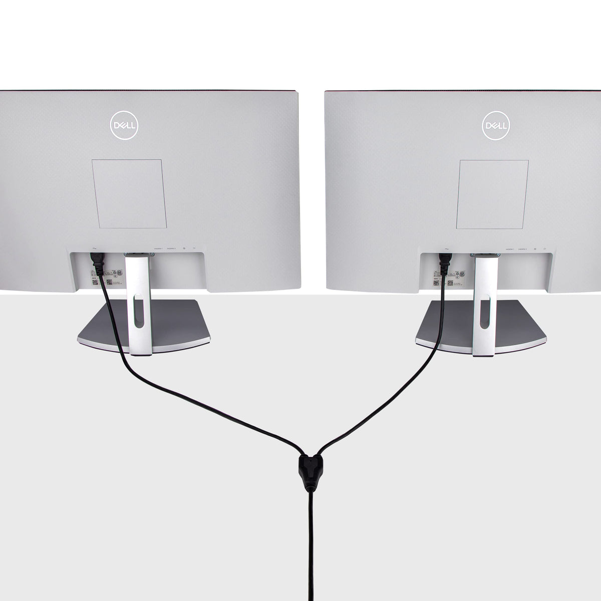 Black StarTech.com power Y-Cable in use powering two devices on a desk.