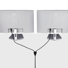 Black StarTech.com power Y-Cable in use powering two devices on a desk.