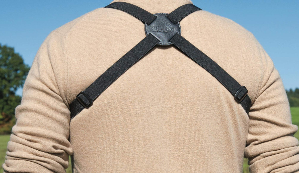 Steiner harness worn by birdwatcher demonstrating hands-free viewing advantage