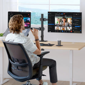Suptek laptop tray on monitor arm enables compact, organized desk setups.