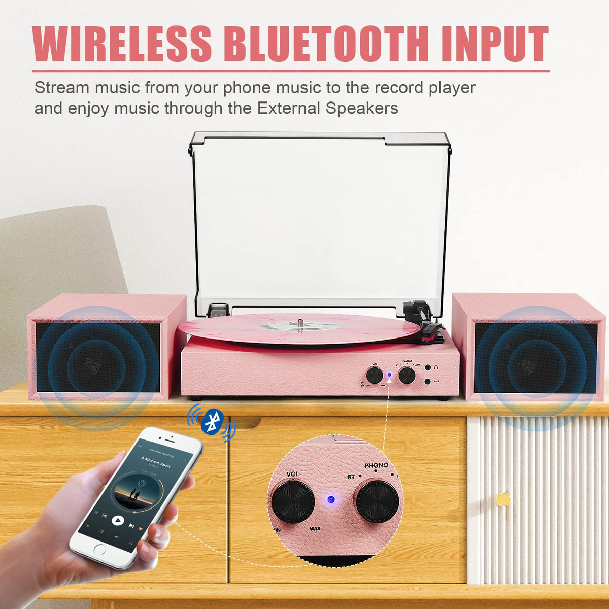 Tanlanin pink dual speakers paired with the turntable for immersive sound.