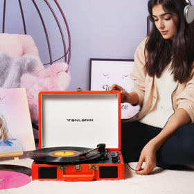 TANLANIN next to a 12-inch vinyl showing compact scale and portability benefit