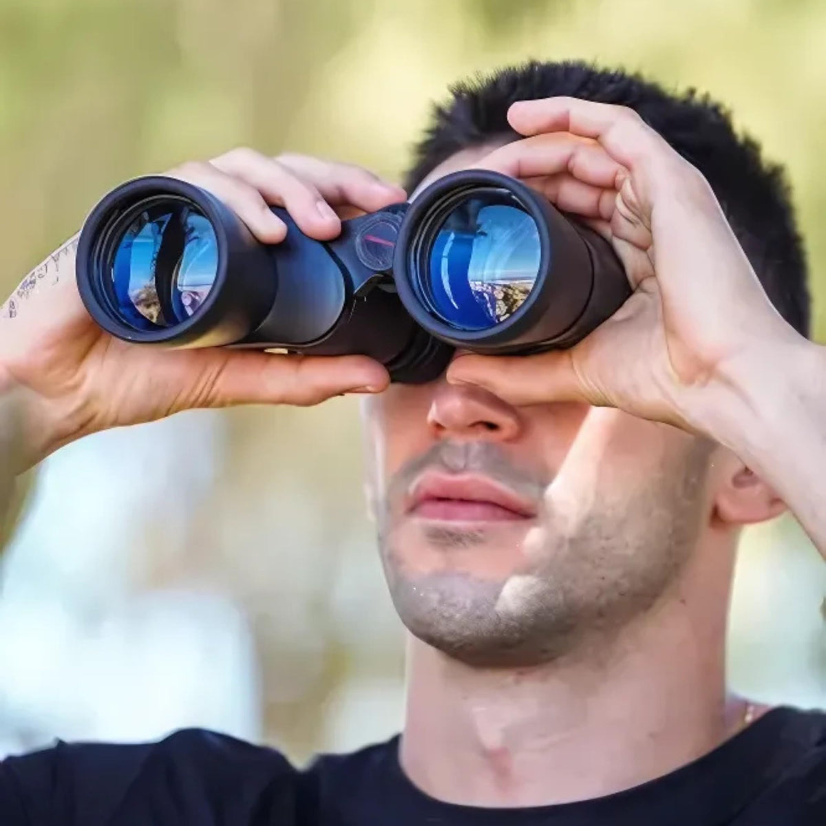 TASCO binoculars held in hand to show size and 27-ounce lightweight portability