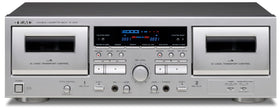 Teac W-1200 dual cassette deck front view in silver, ideal for playback and recording.