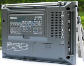 TECSUN R9700DX held in hand to show compact size and lightweight portability for travel