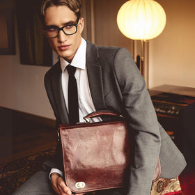 Time Resistance briefcase laptop compartment fits up to 15 inches for convenient tech transport.