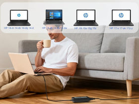 Tinkon charger beside laptop showing compact size for travel convenience