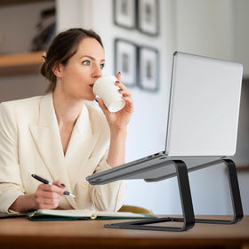 Tonmom next to keyboard showing under-stand storage and space-saving benefit