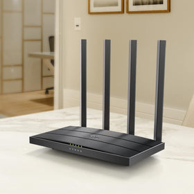 TP-Link Archer A6 size comparison with hand to show compact footprint and placement flexibility