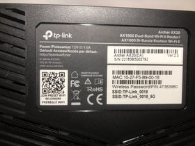 TP‑Link Archer AX20 packaging and accessories illustrating included cables and manual