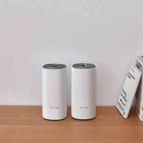 TP-Link Deco W2400 placed in a living room demonstrating mesh coverage and steady streaming benefit