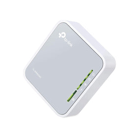 TP-Link TL-WR902AC beside laptop in travel setting providing reliable portable Wi-Fi