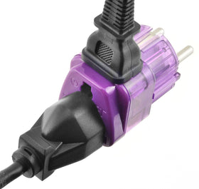 TRAVEL READY adapter plugged into wall powering two devices, demonstrating size and dual outlets