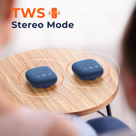 Tribit StormBox Micro 2 beside smartphone showing compact scale and easy pocketability