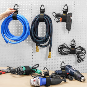 Trilancer hose organizer strap mounted on a wall keeping garden hoses tidy.