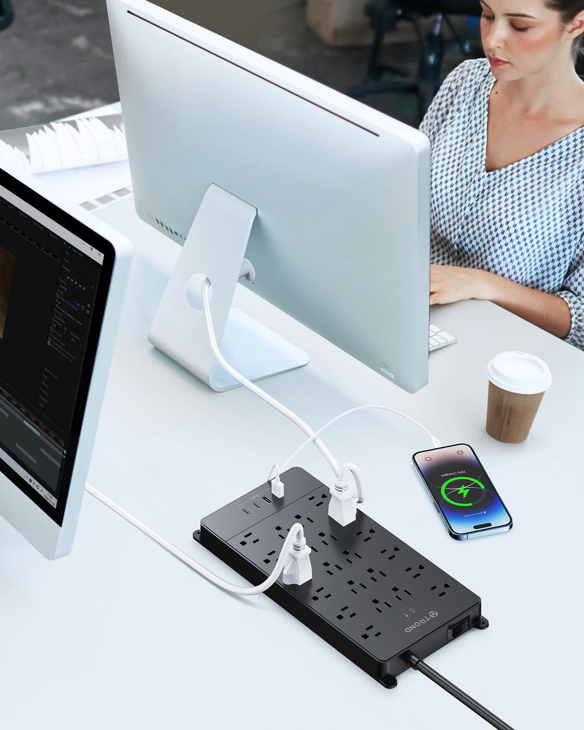 TROND beside a laptop for scale, conveys compact footprint while powering multiple devices