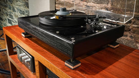 Cork pad placed under turntable corner for stability