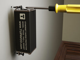 Tupavco TP302 installed on an exterior wall near network cabling to protect outdoor gear