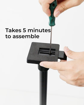 ULTIMEA stand beside a book showing scale to visualize speaker height and footprint