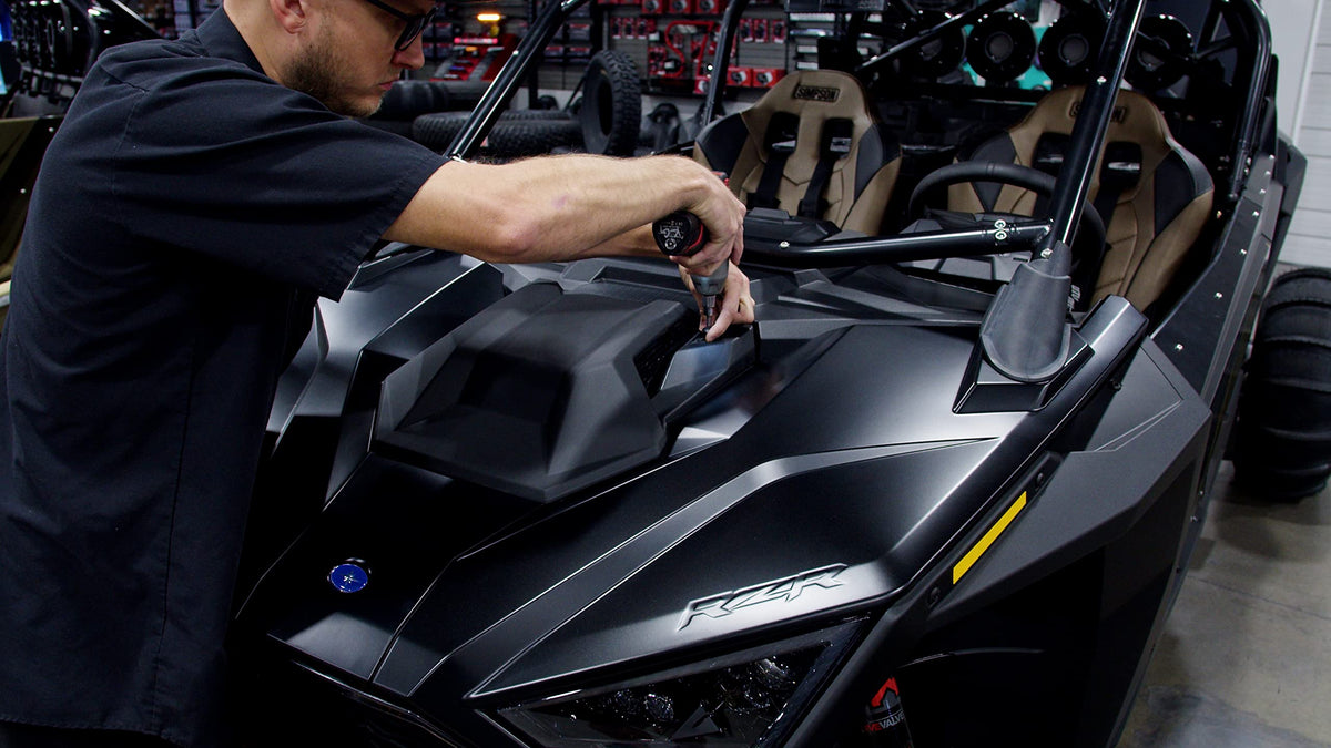 UTV Stereo grille removal frame shows camera clip snapping into place