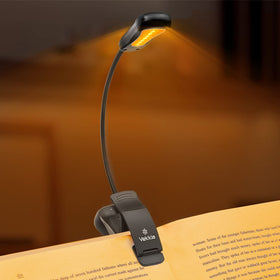 Vekkia Amber Rechargeable 7 book light clipped on a page for easy night reading