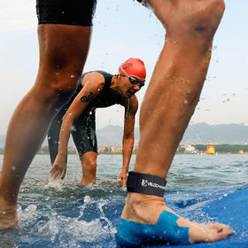 VeloChampion worn on athlete ankle during race illustrating stability and low profile