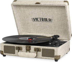 Victrola Journey portable suitcase record player on a table with vinyl ready to play