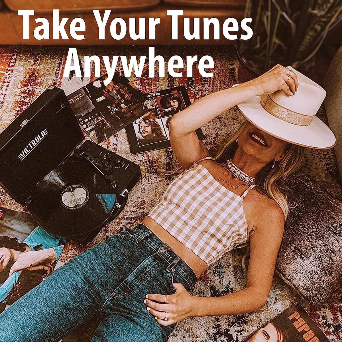 Victrola Journey+ lifestyle person carrying the suitcase turntable showing easy transport benefit