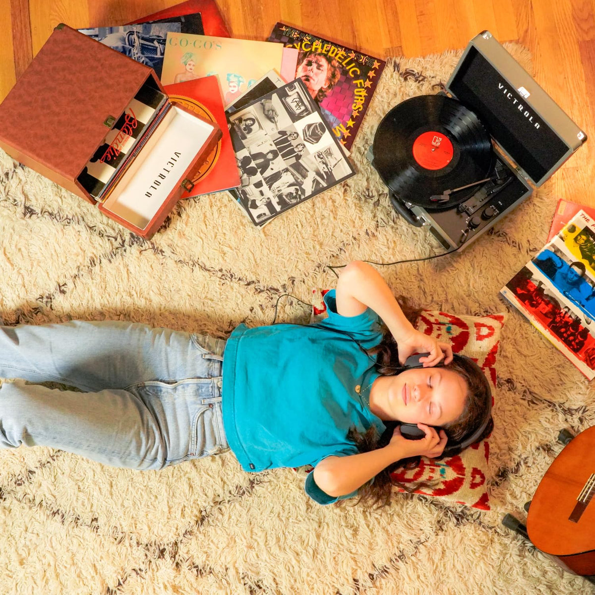 Victrola case on a shelf beside a turntable showing coordinated style and storage
