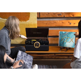 Victrola Metropolitan espresso in a living room corner demonstrating 4-in-1 versatility.
