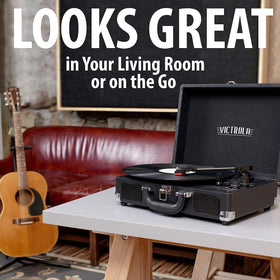 Victrola Parker beside a vinyl sleeve for scale, showing compact suitcase portability