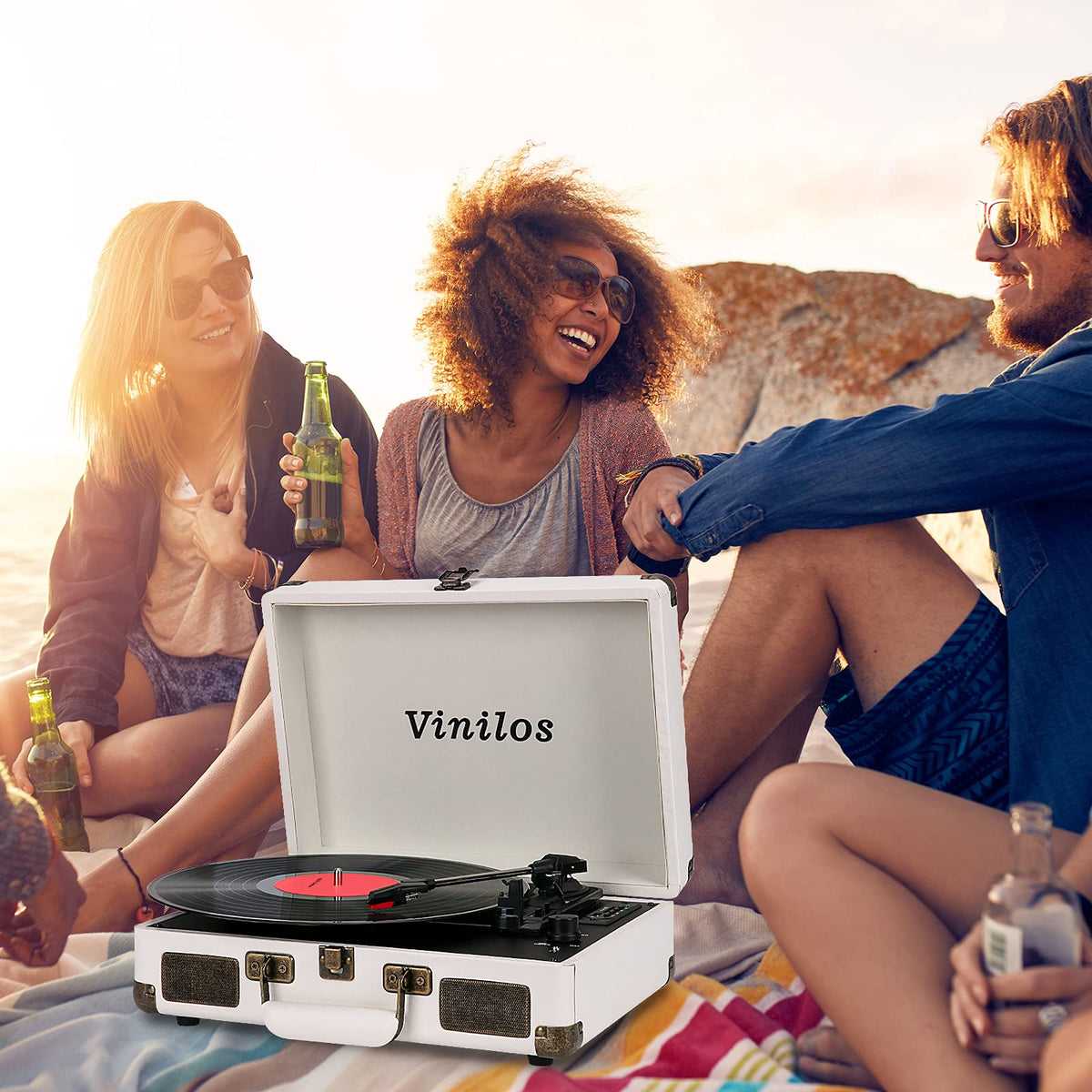 VINILOS next to a hand to show compact size and effortless transport convenience