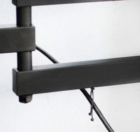 VIVO mounted with a person for scale showing fit for 23-55 inch TVs benefit