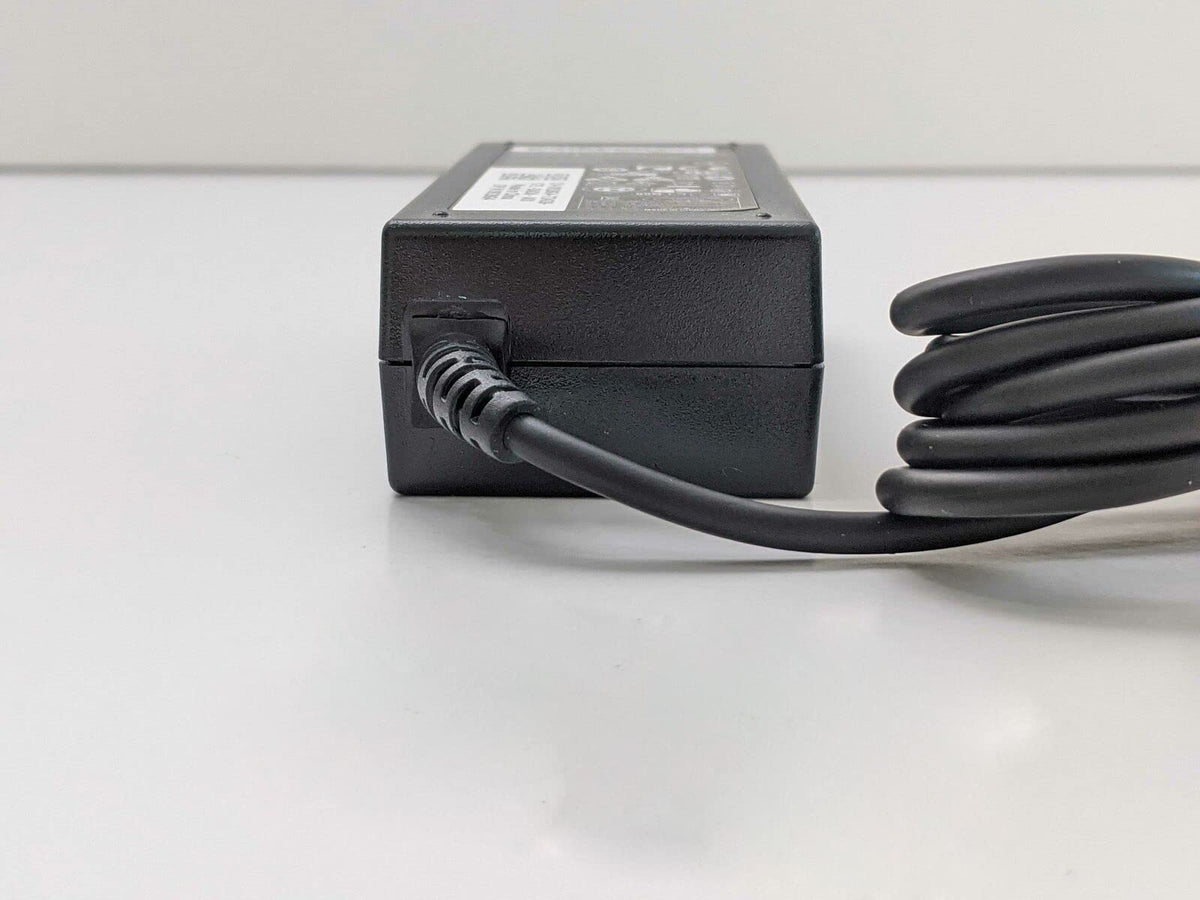 WEALLGOOD charger plugged into Dell laptop on desk showing reliable power